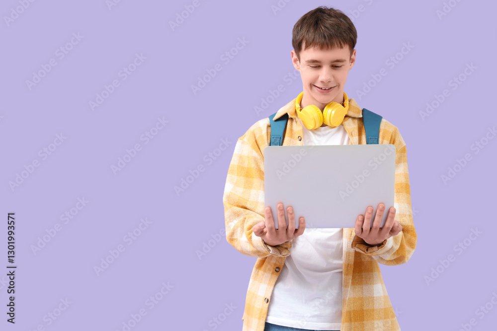 Teenage boy with backpack and laptop on lilac background Teenage boy with backpack and laptop on lilac background