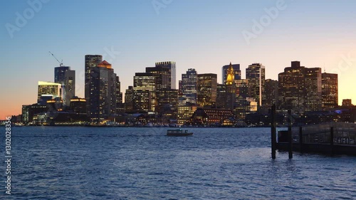 View of Boston city skyline seen from Piers Park during late winter evening