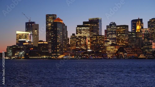 View of Boston city skyline seen from Piers Park during late winter evening