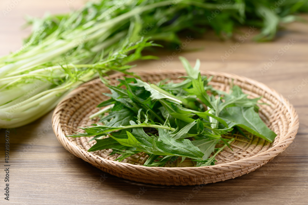 Mizuna, Water green, Japanese mustard green or spider mustard in basket on wooden background Mizuna, Water green, Japanese mustard green or spider mustard in basket on wooden background