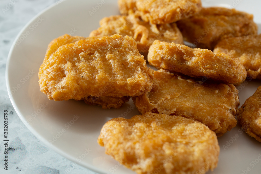 A closeup view of restaurant style chicken nuggets. A closeup view of restaurant style chicken nuggets.