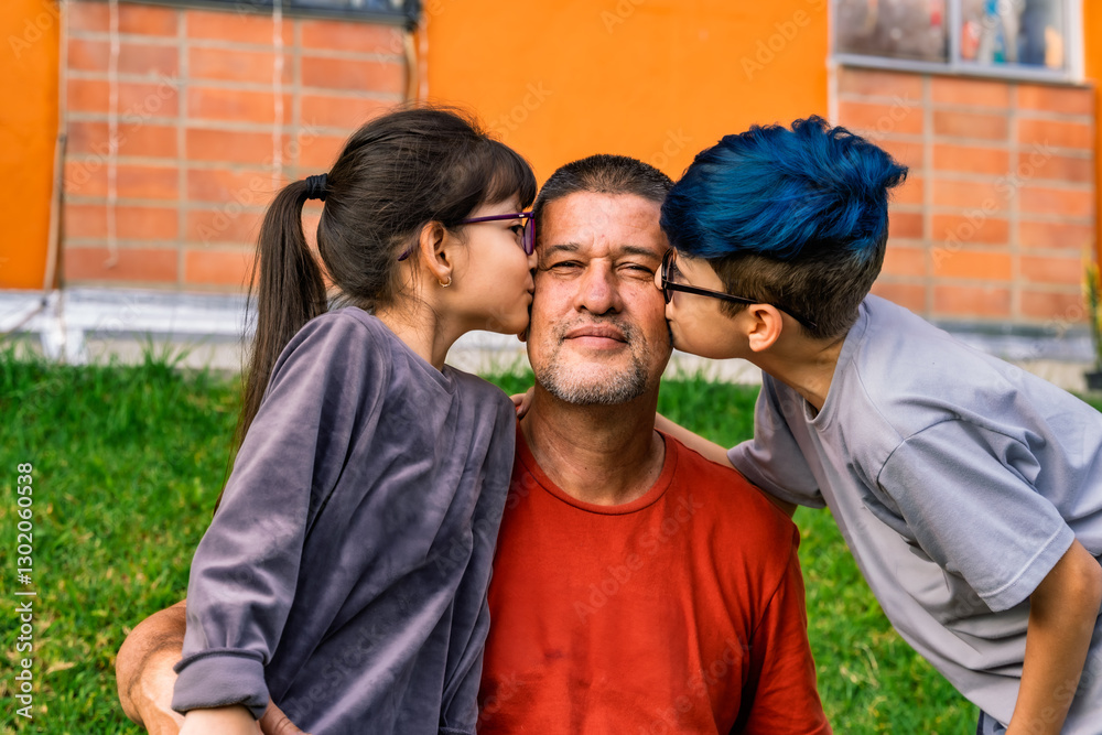 Obraz premium Photo of Colombian Latino grandfather looking into camera smiling with his two mestizo grandchildren kissing him on each cheek.