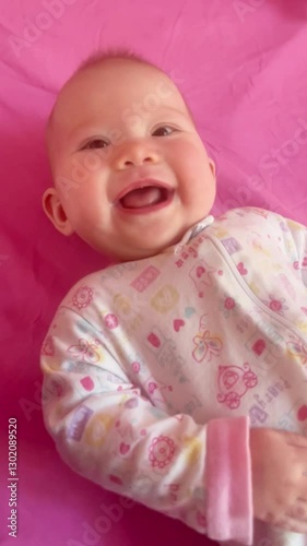 Mother playing with an infant baby by touching her nose. Happy healthy baby concept. Giggling newborn baby girl looking at her mom. Smiling baby girl. Happy emotions. Mom and child