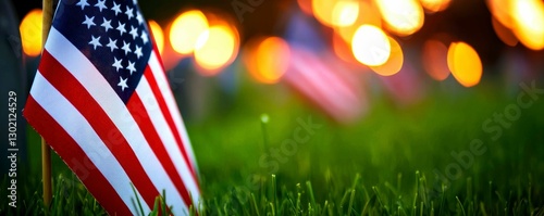 American Flag Displayed in Green Grass Bokeh Lights Honor and Remembrance Patriotic Occasion Memorial photo