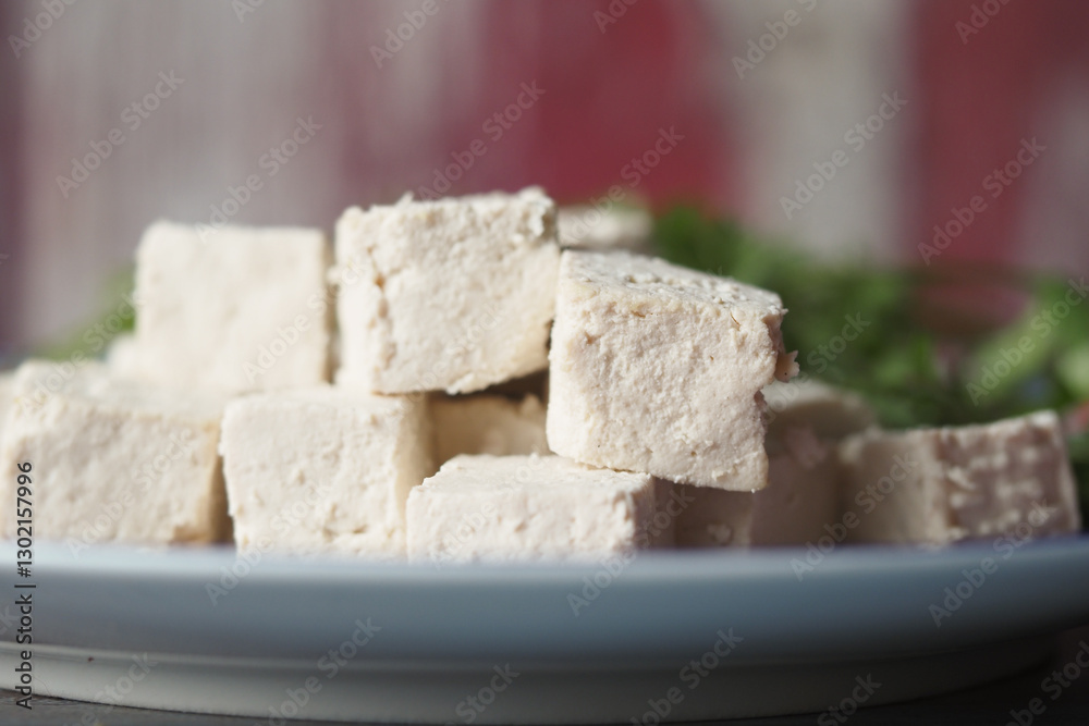 Freshly cut tofu served on a plate with herbs Freshly cut tofu served on a plate with herbs