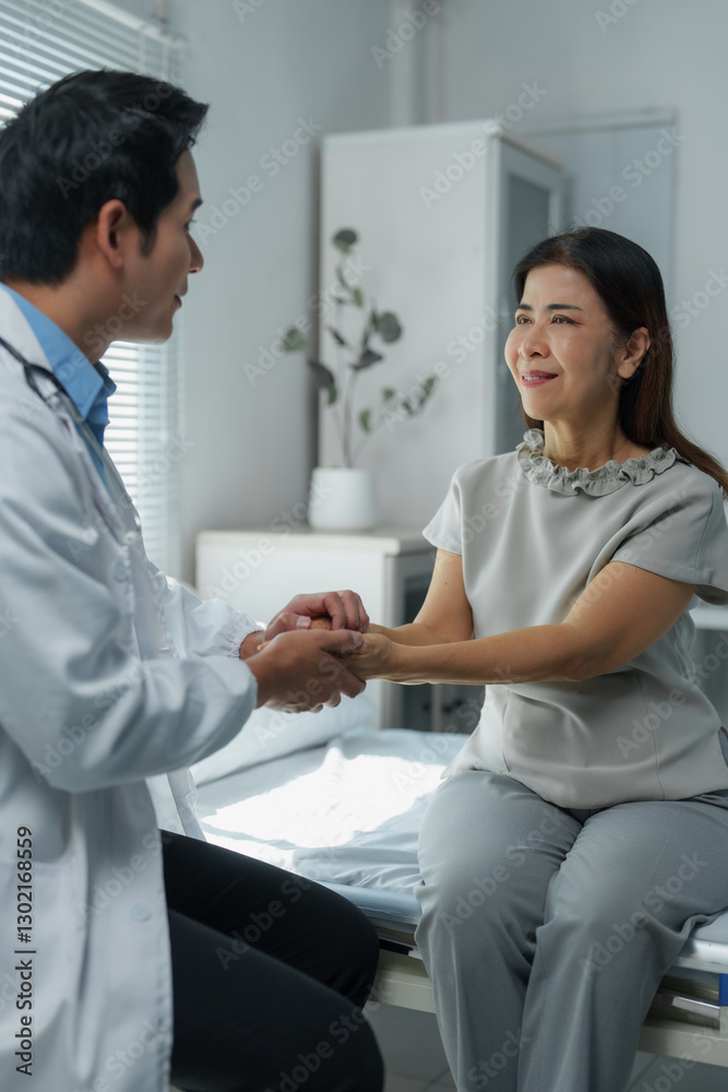 Fototapeta premium Doctor comforting patient by holding hands in hospital room