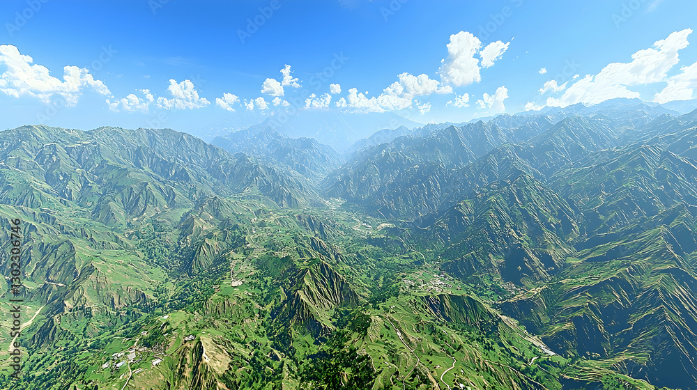 Fototapeta premium Aerial valley view with green mountains, agricultural fields, distant village, and cloudy sky