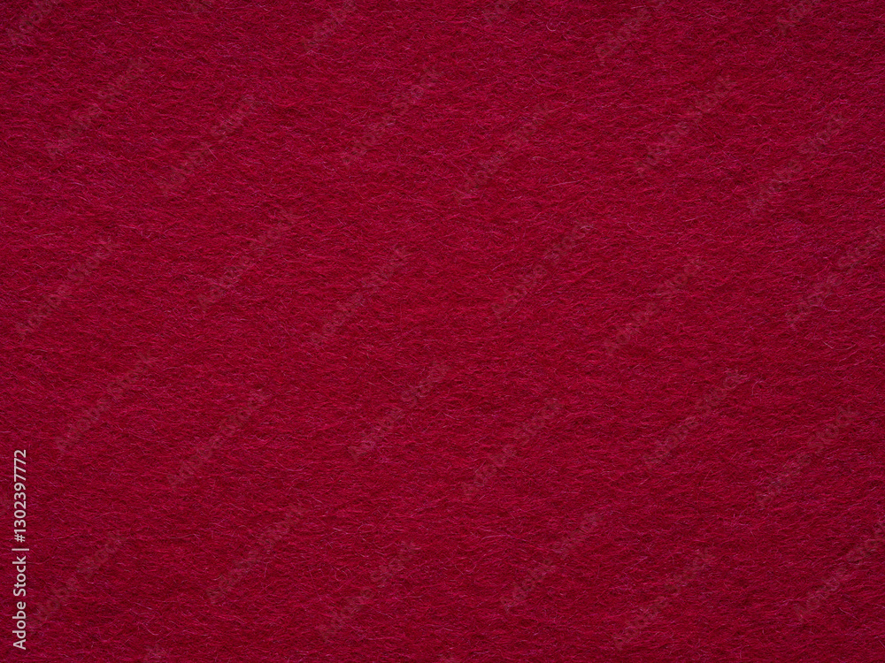 A luxurious expanse of deep red felt, evoking warmth and sophistication in its sumptuous texture