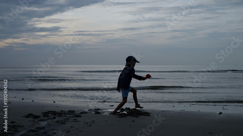 A little boy running on the beach with fun and happiness.