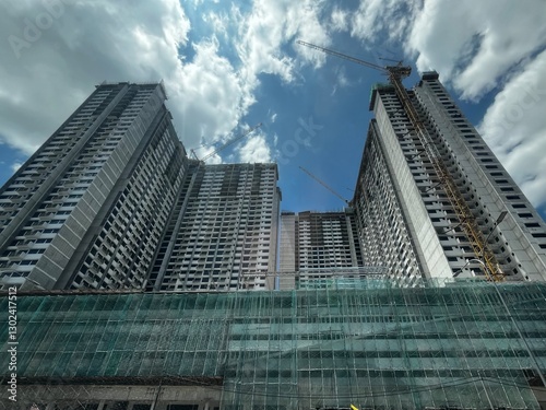 A building under construction, with scaffolding wrapping around the structure, showcasing ongoing progress, skyscrapers in the city