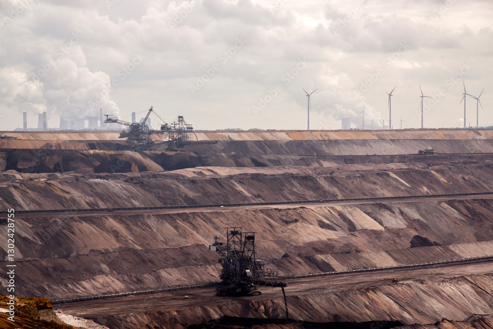 Germany, North Rhine Westphalia, -june 2017: ground excavator in action moving mullock and soil at open pit coal mine; Germany,for winning brown coal