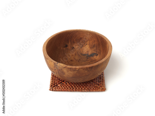 Wooden Bowl With Intricate Design Placed on a Woven Coaster