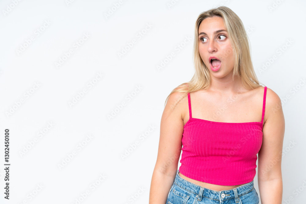 Young caucasian woman isolated on white background doing surprise gesture while looking to the side Young caucasian woman isolated on white background doing surprise gesture while looking to the side