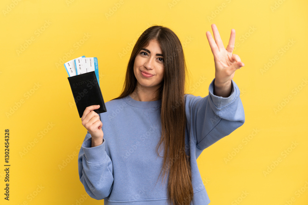 Young caucasian woman holding a passport isolated on yellow background happy and counting three with fingers Young caucasian woman holding a passport isolated on yellow background happy and counting three with fingers
