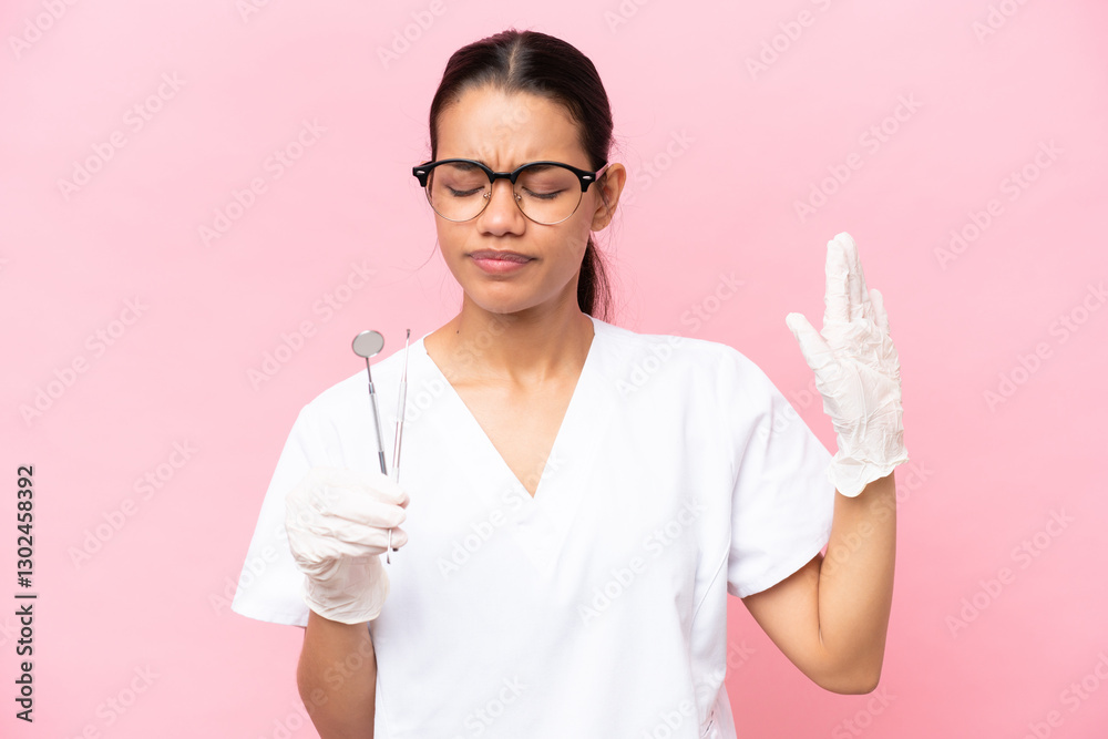 Dentist Colombian woman isolated on pink background making stop gesture and disappointed Dentist Colombian woman isolated on pink background making stop gesture and disappointed