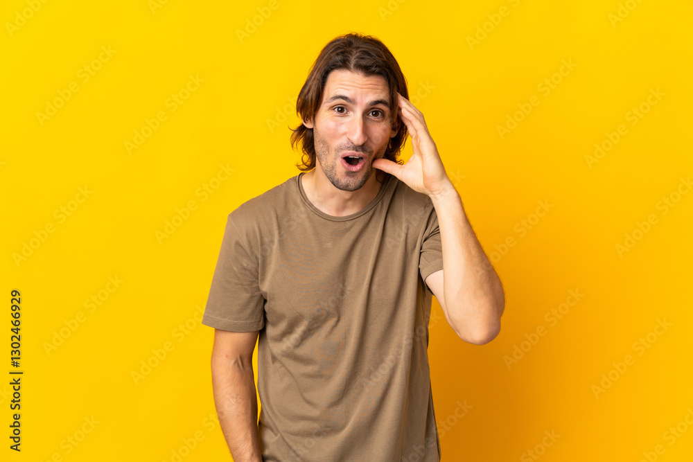 Young handsome man isolated on yellow background has realized something and intending the solution Young handsome man isolated on yellow background has realized something and intending the solution