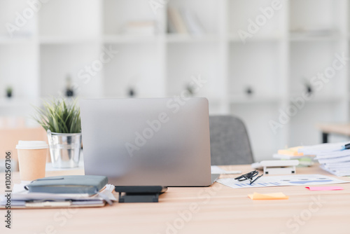 Wallpaper Mural Asian businesswoman in red sweater stretches her arms while sitting at desk with laptop and stacked documents, expressing relaxation. Torontodigital.ca
