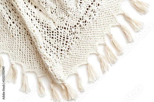 Closeup of cream crocheted throw blanket with tassels, isolated on white background