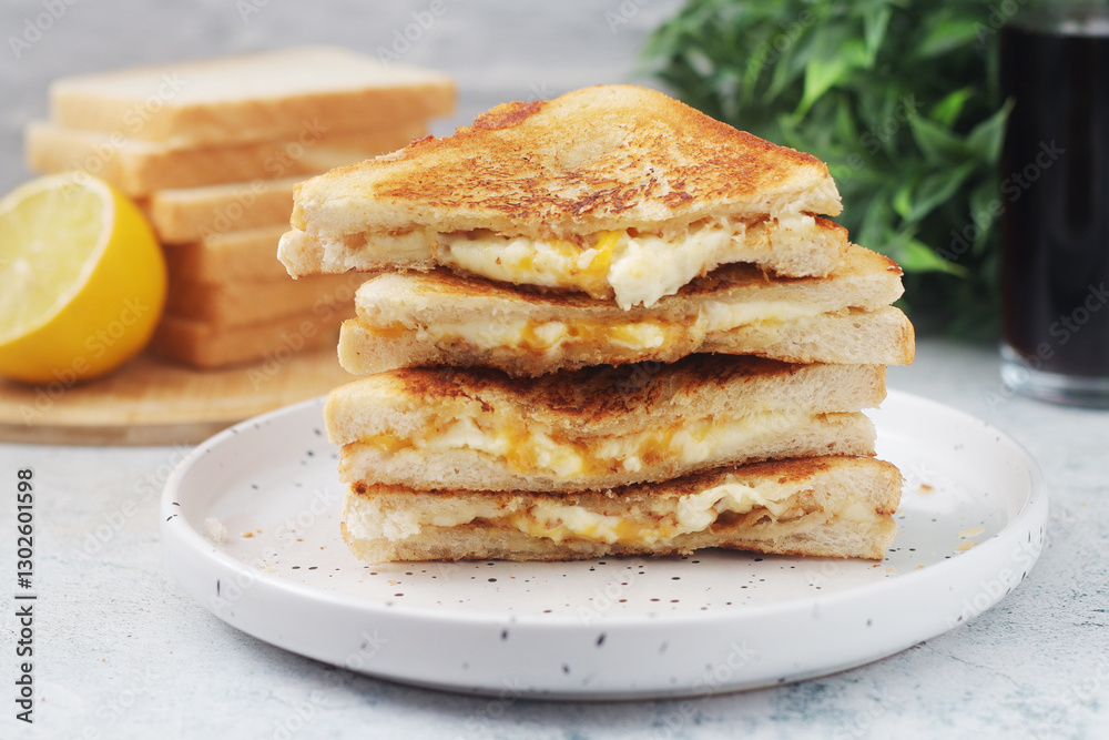 Grilled cheese sandwiches served for eating Grilled cheese sandwiches served for eating