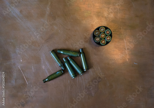 Bullet casings or shot casings on the copper background. Russian roulette metaphor. Deadly games. Senseless war concept. photo