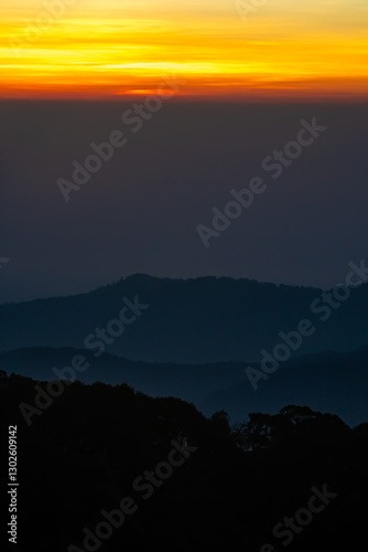 The beautiful sunrise at Doi intanon national park, Chiang Mai in the morning.Sun is rising from the hill to shy with beautiful yellow orange light. photo