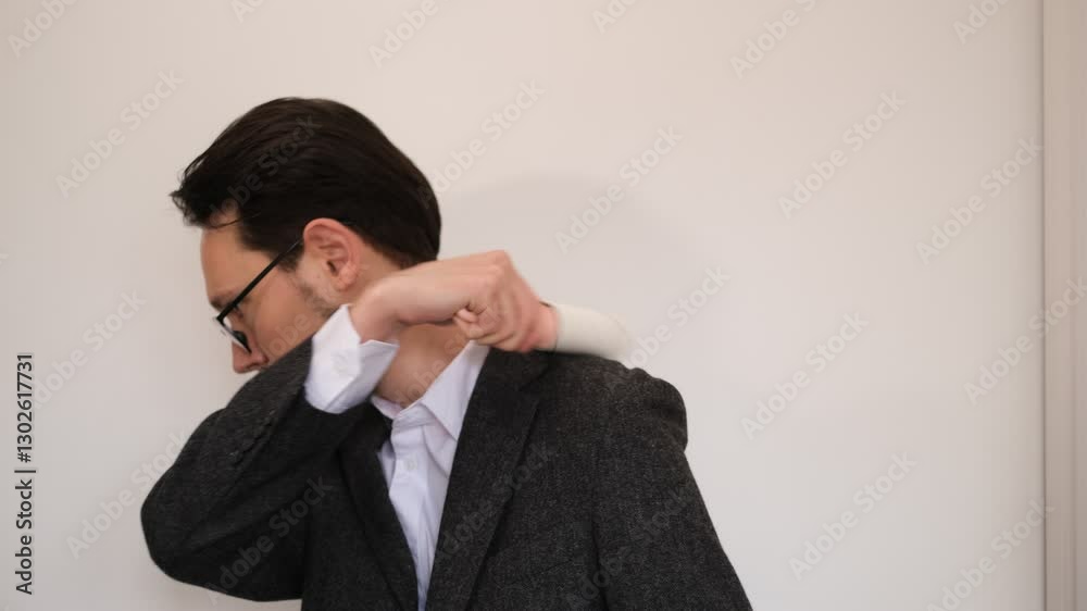 Young man cleaning his jacket with a clothes roller Young man cleaning his jacket with a clothes roller