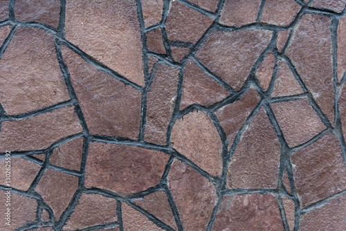 A detailed view of a natural stone pathway showcasing a blend of earth tones and varying shapes. This walkway adds character to the urban landscape, inviting visitors to explore.