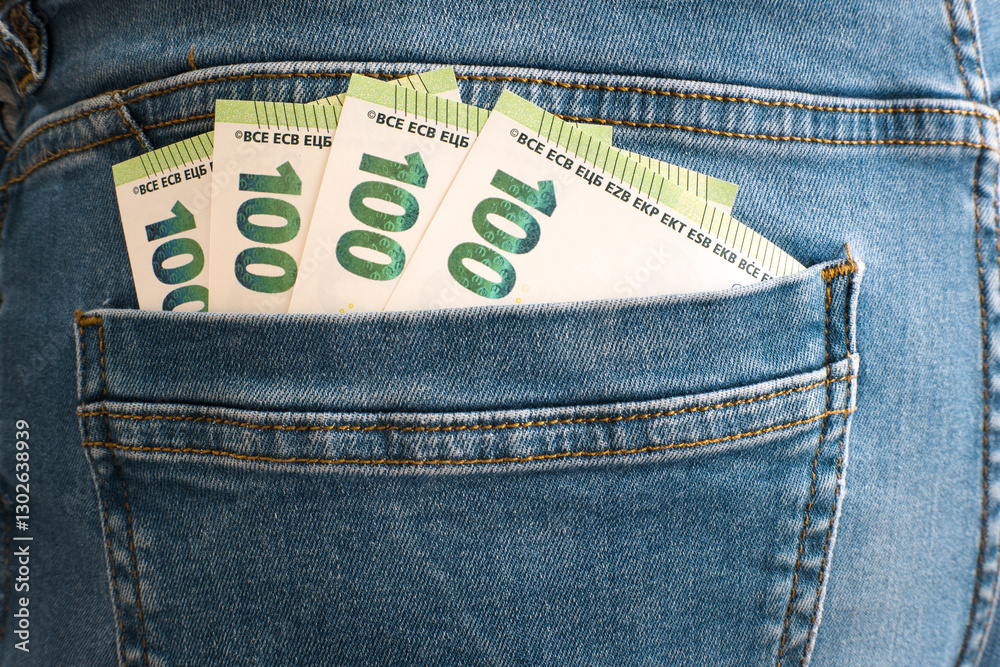 Euro banknotes in trouser pocket.