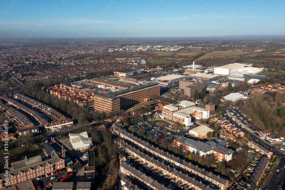 Aerial drone photo of the city of York in North Yorkshire, England showing the large Nestle chocolate factory in the city showing the large building surrounded by houses and homes in the winter time