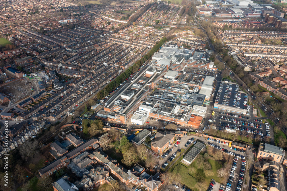Aerial drone photo of the city of York in North Yorkshire, England showing the large buildings that make up the NHS York Hospital buildings surrounded by streets of terrace houses in the winter time