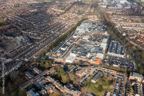 Obraz na płótnie Aerial drone photo of the city of York in North Yorkshire, England showing the large buildings that make up the NHS York Hospital buildings surrounded by streets of terrace houses in the winter time w salonie