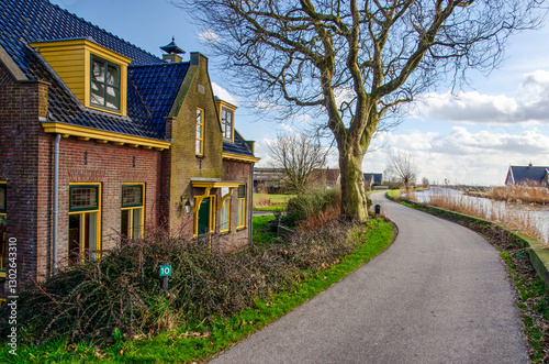 Woerdense Verlaat, The Netherlands, February 26, 2025: brick house next to a road along a canal photo