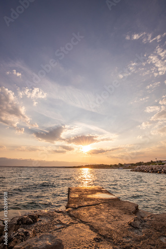 Fototapeta Naklejka Na Ścianę i Meble -  Bay with a small harbor, in the morning. Beautiful sunrise on the Mediterranean Sea. Mediterranean coast and landscape Beach Plaža Lozice on the island of Vir, Zadar, Dalmatia, Adriatic Sea, Croatia