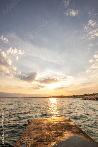 Fototapeta Naklejka Na Ścianę i Meble -  Bay with a small harbor, in the morning. Beautiful sunrise on the Mediterranean Sea. Mediterranean coast and landscape Beach Plaža Lozice on the island of Vir, Zadar, Dalmatia, Adriatic Sea, Croatia