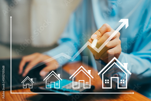 Businessperson Analyzing Housing Market Trends with Graphs and Home Icons on Tabletop, Business concept.