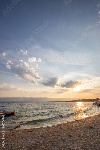Fototapeta Naklejka Na Ścianę i Meble -  Bay with a small harbor, in the morning. Beautiful sunrise on the Mediterranean Sea. Mediterranean coast and landscape Beach Plaža Lozice on the island of Vir, Zadar, Dalmatia, Adriatic Sea, Croatia