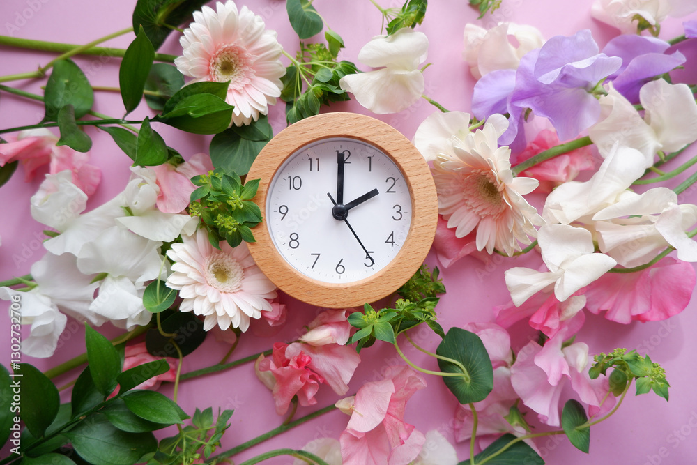 Spring forward background. Beautiful flowers and a clock composition on pastel color background. Spring image and floral background.