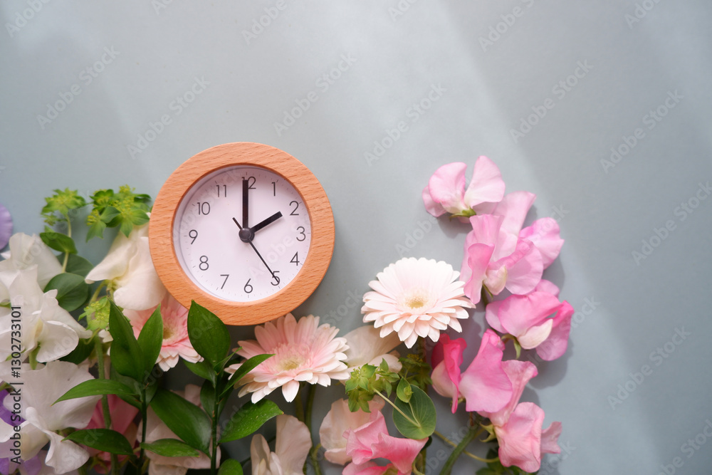 Spring forward background. Beautiful flowers and a clock composition on pastel color background. Spring image and floral background.