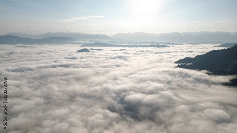 view of towering mountains enveloped in a sea of mist, with the soft glow of the morning sun casting a warm and peaceful light across the landscape. The mist creates an ethereal atmosphere, enhancing view of towering mountains enveloped in a sea of mist, with the soft glow of the morning sun casting a warm and peaceful light across the landscape. The mist creates an ethereal atmosphere, enhancing