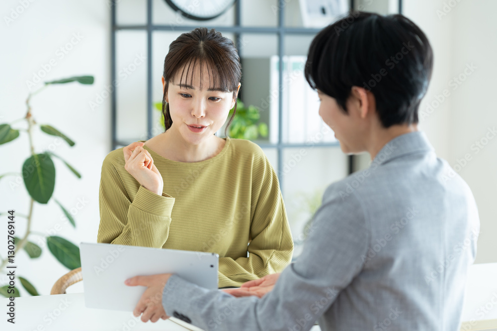 Obraz premium プランナーに相談する若い女性