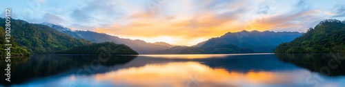 Sunrise over mountain lake, scenic reflection