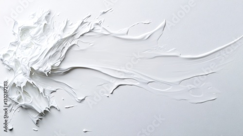 Smooth white paint spread across a blank canvas creates an abstract artistic texture during a creative session photo