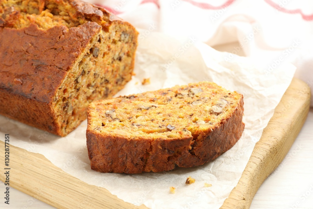Cut homemade carrot cake with nuts on table, closeup Cut homemade carrot cake with nuts on table, closeup
