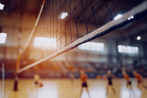 Side view of volleyball net in gym with sunset light. Great for indoor sports backgrounds, youth athletics promotions, fitness events, or volleyball match posters.

