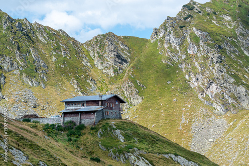 Detail of a mountain hut with the Carpathian Mountains in the background on a summer day