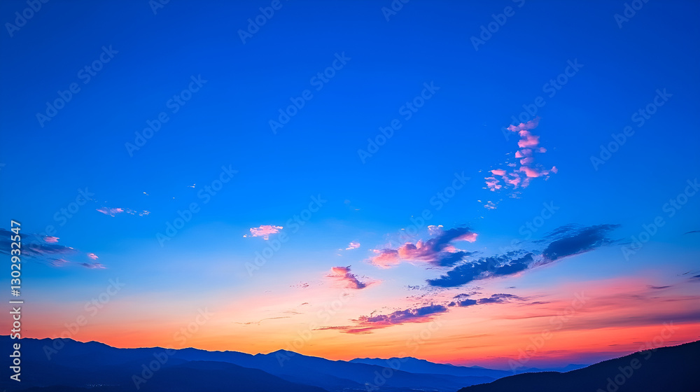 Fototapeta premium Breathtaking sunset over a mountainous landscape with vibrant colors and a clear sky