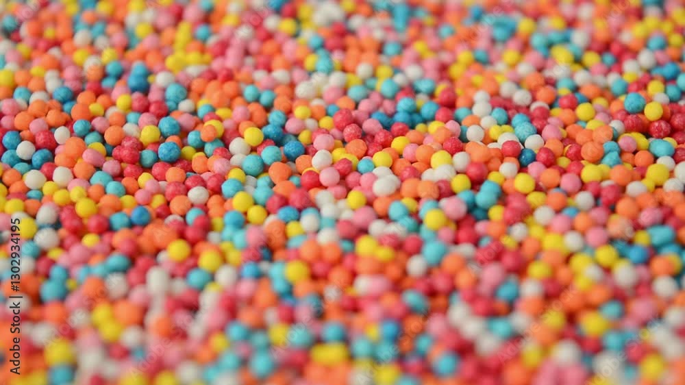 Round colorful confectionery sprinkles rotating. Side view. Baking decoration.
