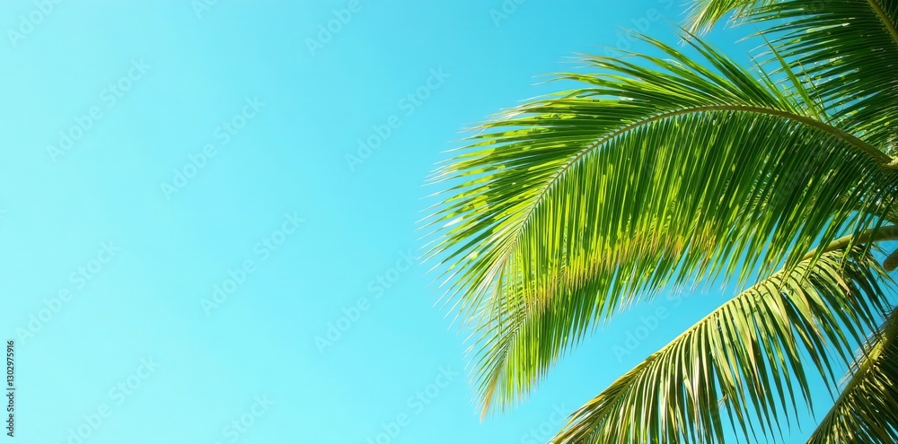 Fototapeta premium Lush palm fronds swaying in the wind against clear blue sky, lush, tranquil, oasis
