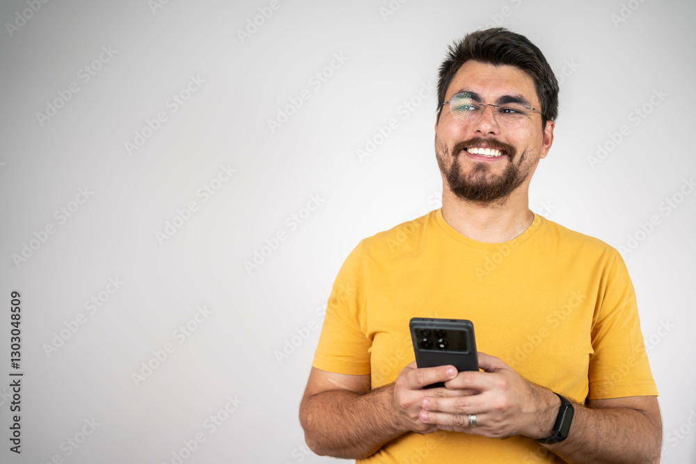 Young happy man looking at his phone. Successful young handsome freelancer using phone isolated. Young happy man looking at his phone. Successful young handsome freelancer using phone isolated.