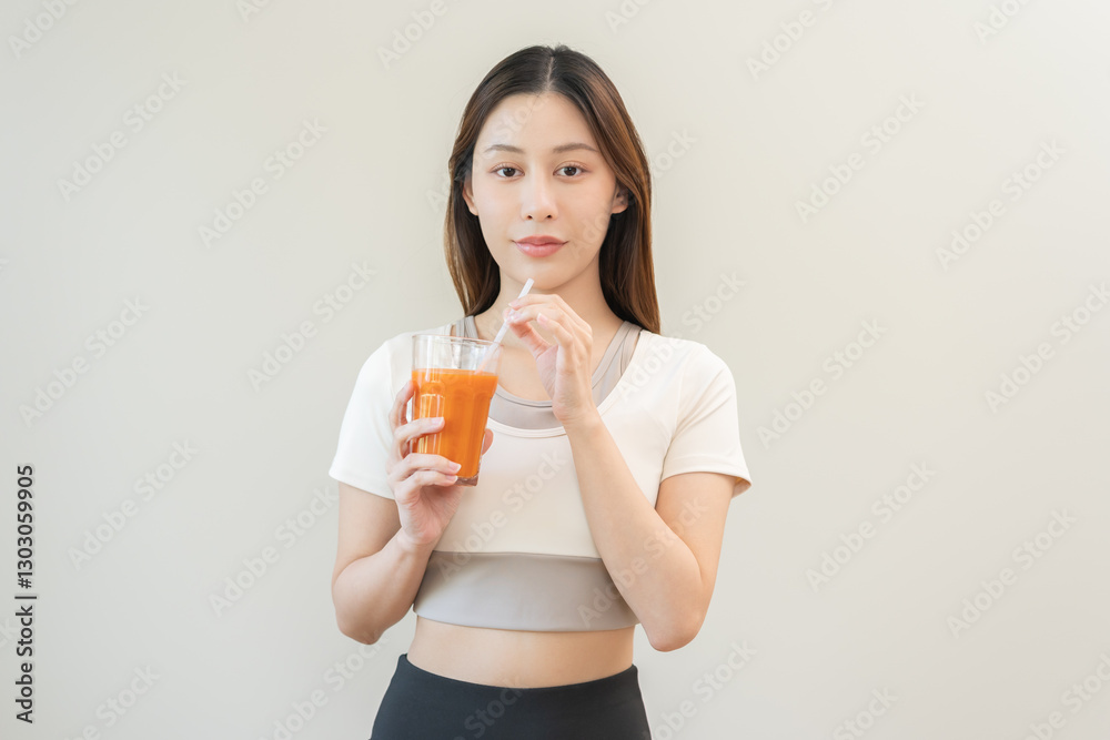 Orange detox juice, smile asian young woman hand holding a glass of vegetable juice, carrot smoothie for diet, drinking healthy meal food for weight loss on background. Lifestyle, vegan nutrition. Orange detox juice, smile asian young woman hand holding a glass of vegetable juice, carrot smoothie for diet, drinking healthy meal food for weight loss on background. Lifestyle, vegan nutrition.